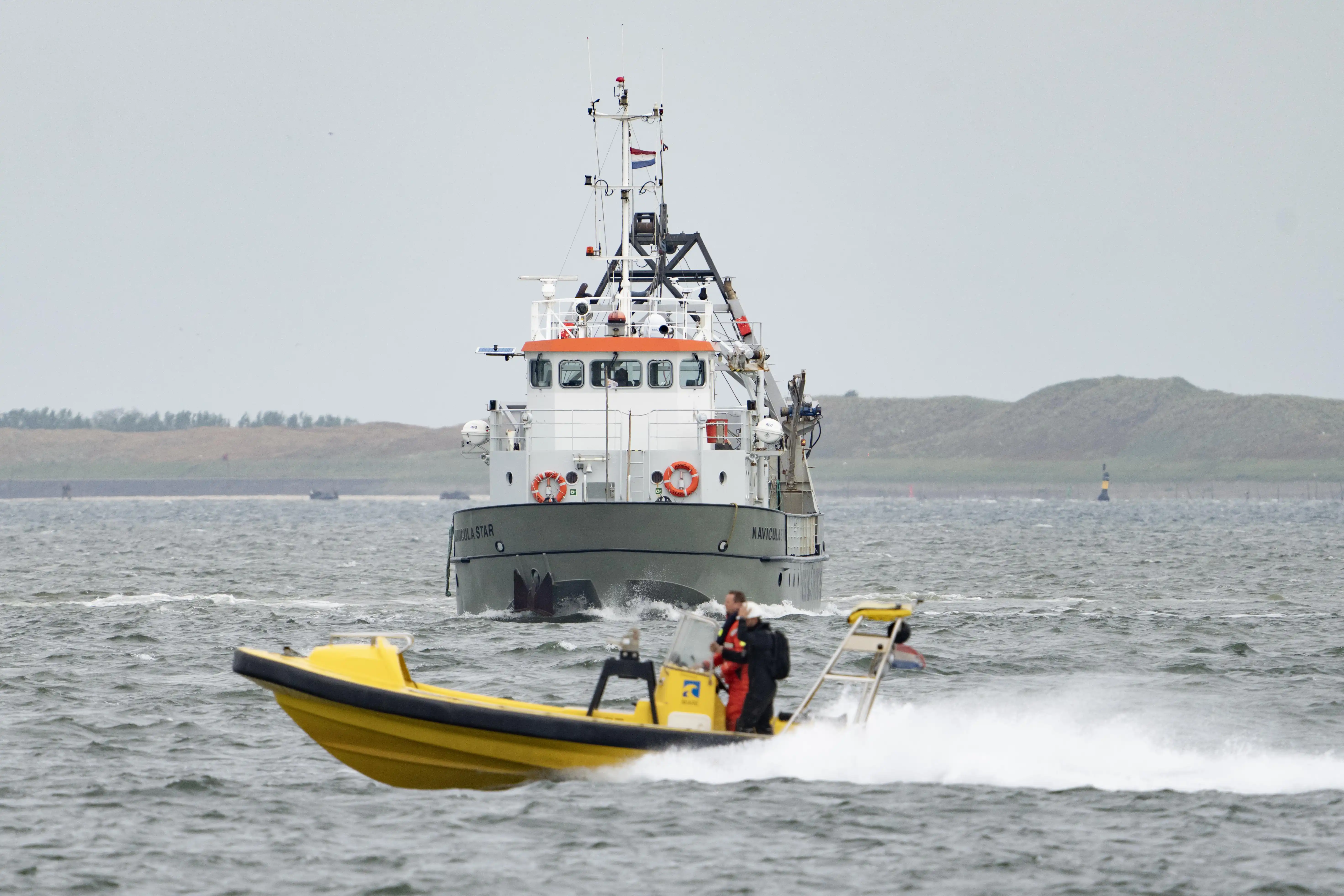 our fleet with a boat in front of it at sea